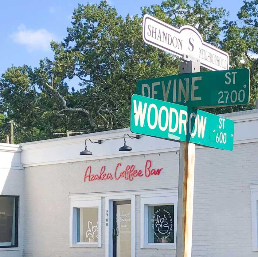 Azalea Coffee Bar behind street signs for Devine and Woodrow in Columbia SC