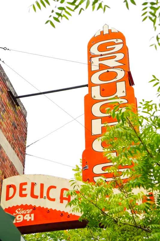 Exterior sign for Groucho's Deli original location in Five Points.