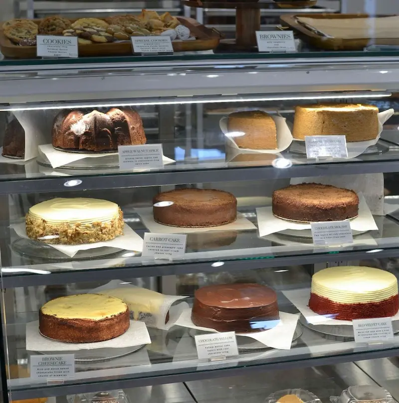 Pastry case full of cakes and cheesecake at Kudzu Bakery in Columbia, SC