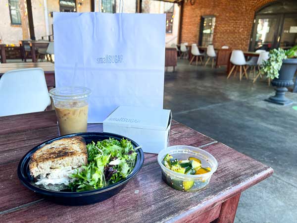 Takeout sandwich and latte at SmallSugar patio in Columbia, SC